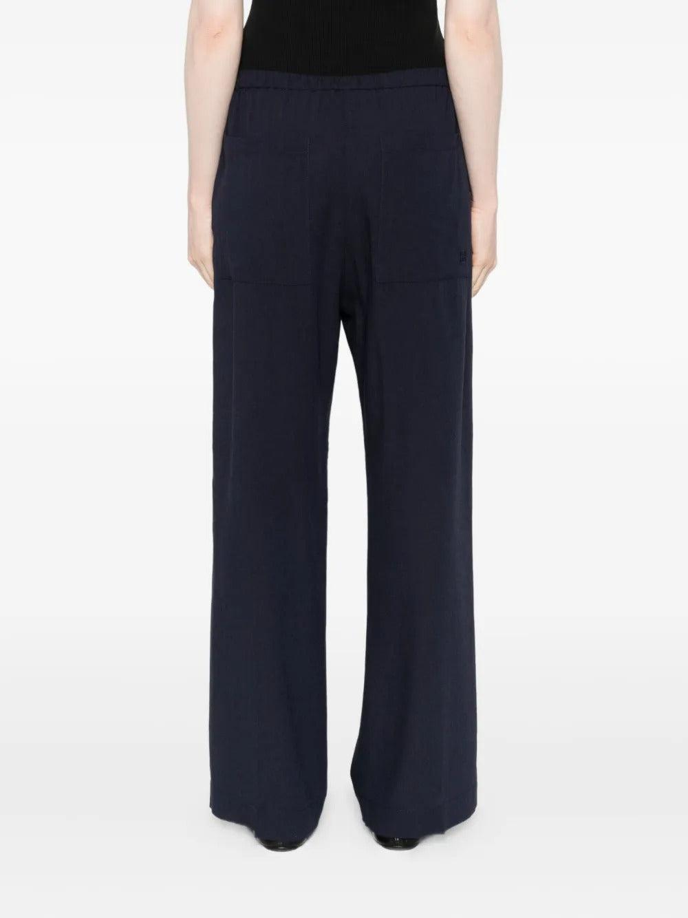 Navy pants worn by a person, showing the pants' fit