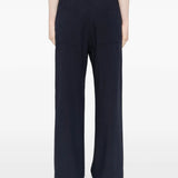 Navy pants worn by a person, showing the pants' fit