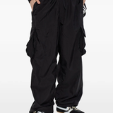 black pants worn by a person, showing the pants fit