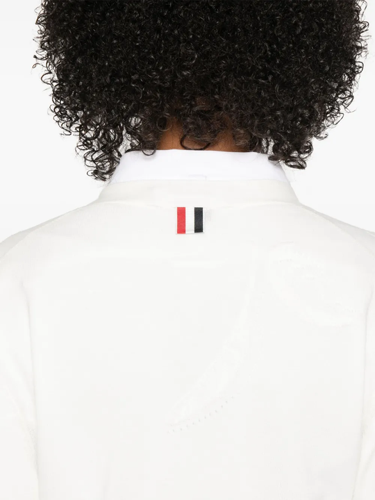 Close up of white knitwear, showing texture of the cotton fabric