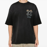 Black t-shirt worn by a person, showing the shirt' fit