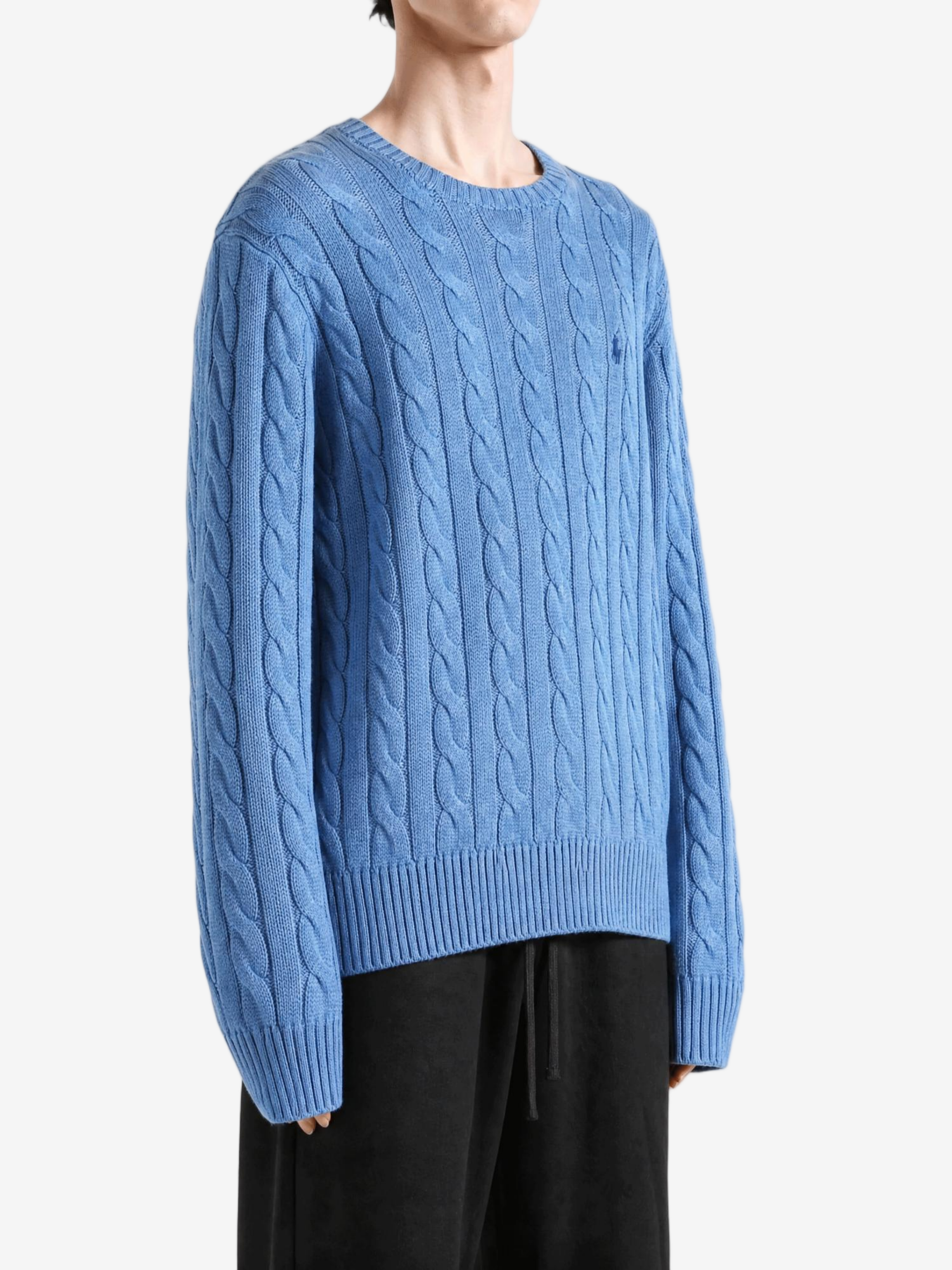 Blue knitwear worn by a person, showing the knitwear fit