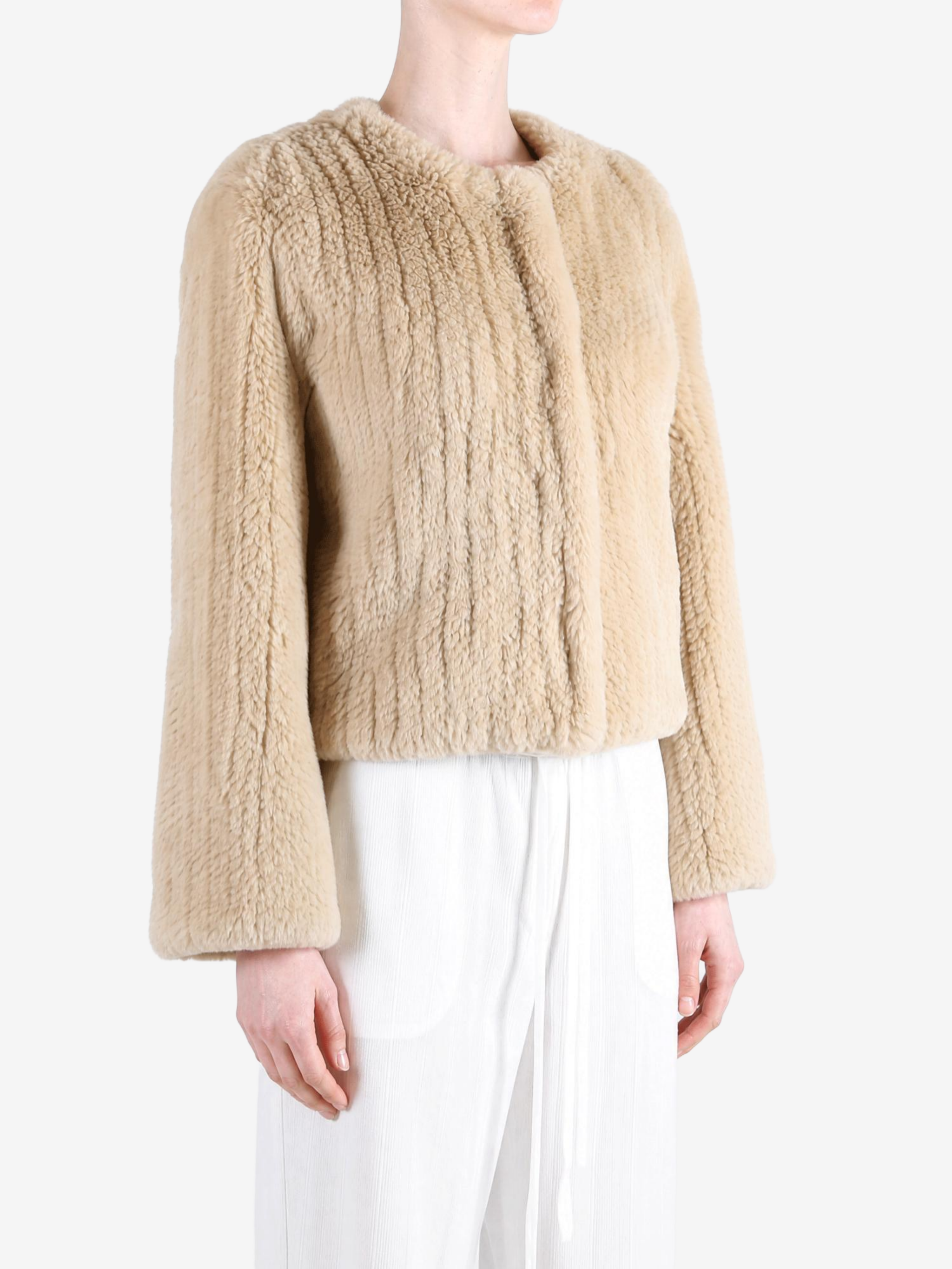 Tan jacket worn by a person, showing the jacket fit