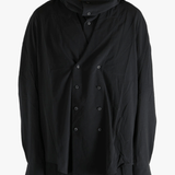 Black shirt worn by a person, showing the shirt's fit