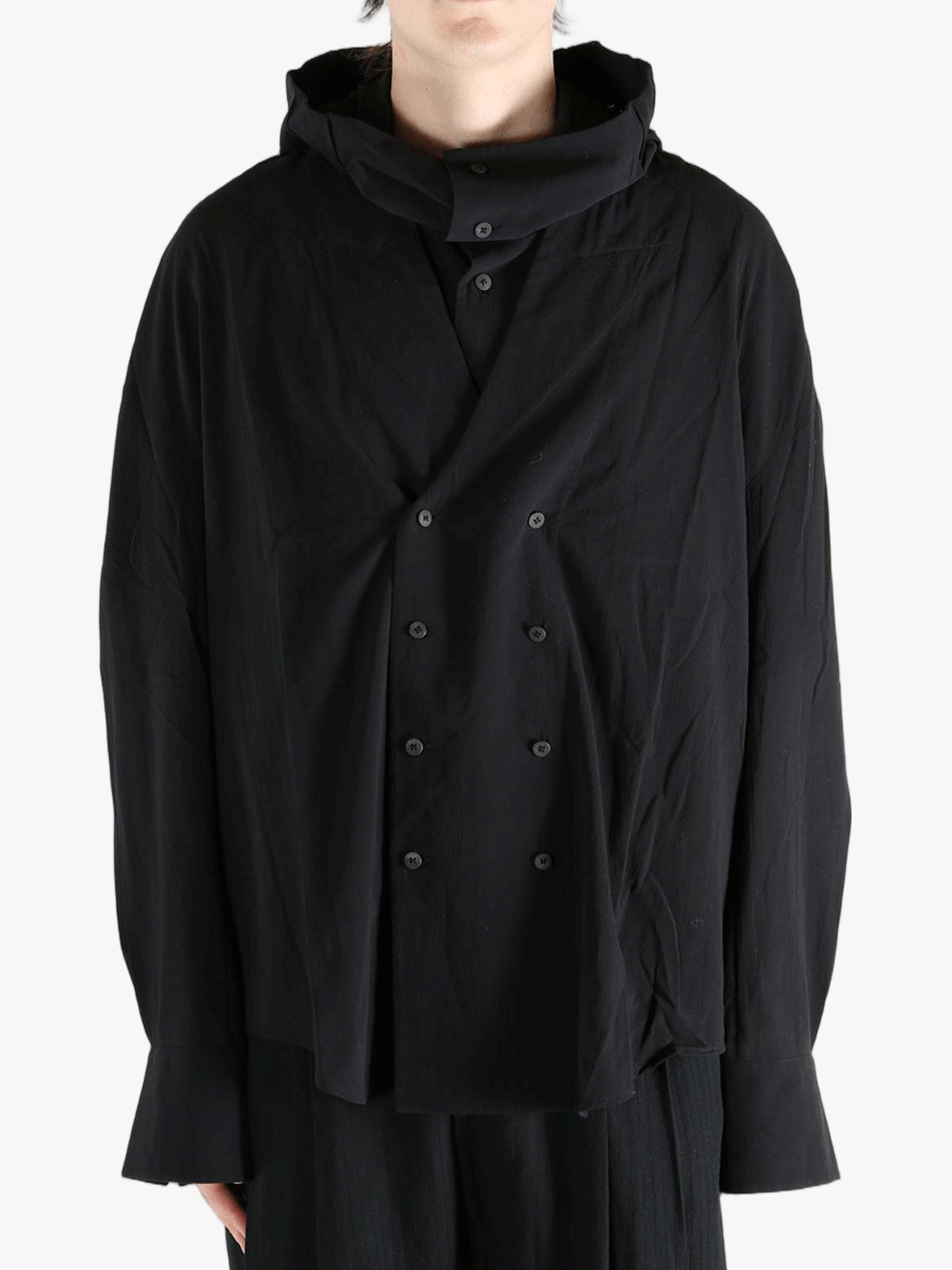 Black shirt worn by a person, showing the shirt's fit