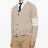 tan knitwear worn by a person, showing the knitwear fit