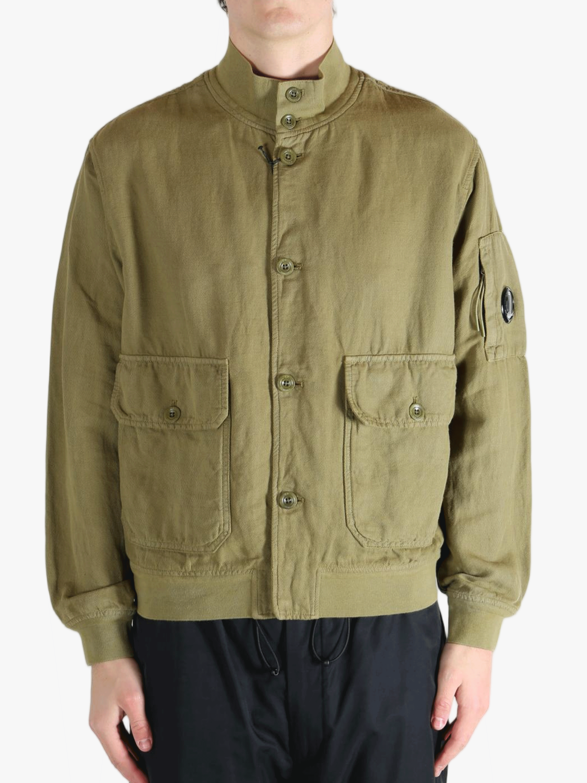 Green jacket worn by a person, showing the jacket's fit