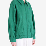 Green jacket worn by a person, showing the jacket fit
