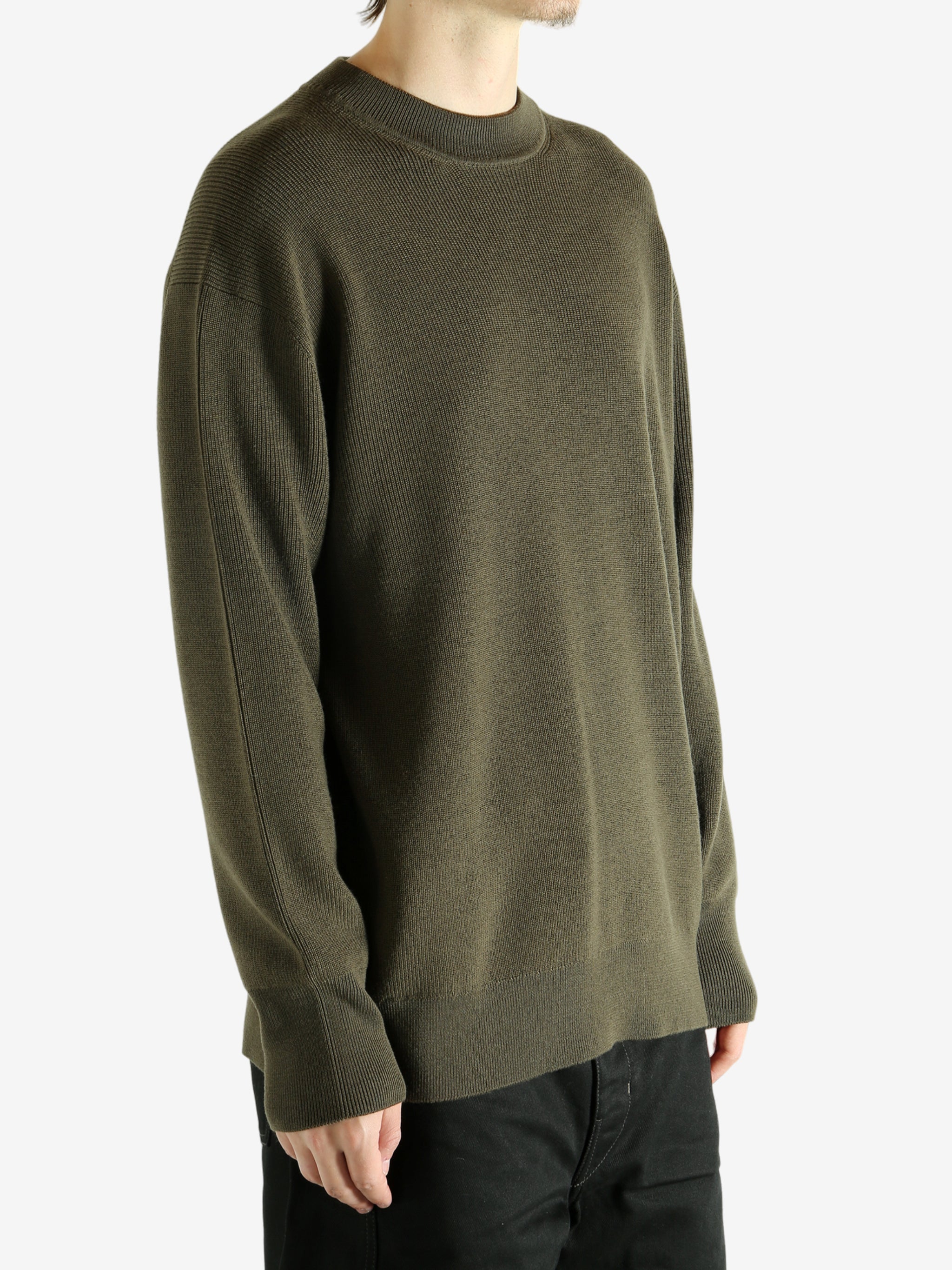 Crew knitwear worn by a person, showing the knitwear's fit