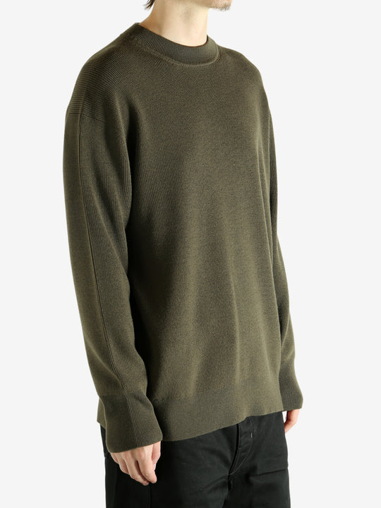 Crew knitwear worn by a person, showing the knitwear's fit