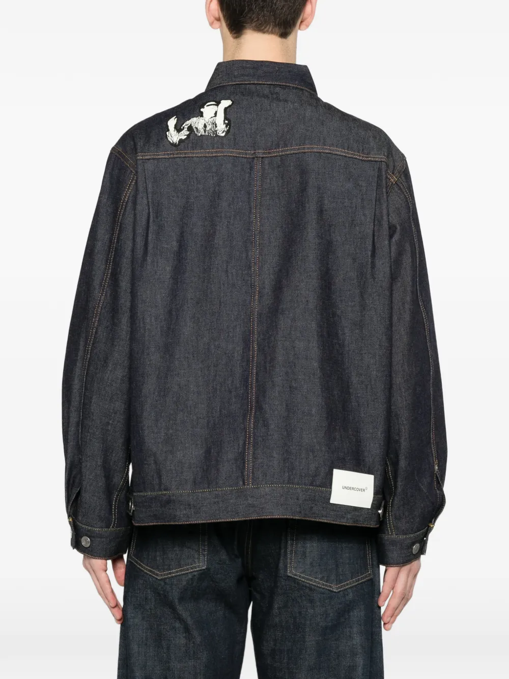 Blue jacket worn by a person, showing the  jacket fit