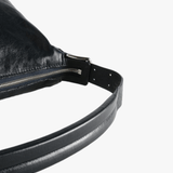 Close up of black bag, showing texture of the leather fabric