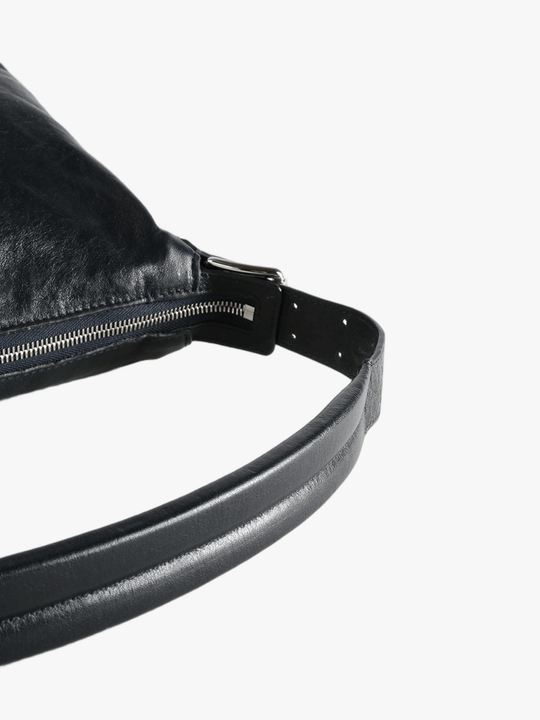 Close up of black bag, showing texture of the leather fabric