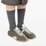 Green shoes worn by a person, showing the shoes fit