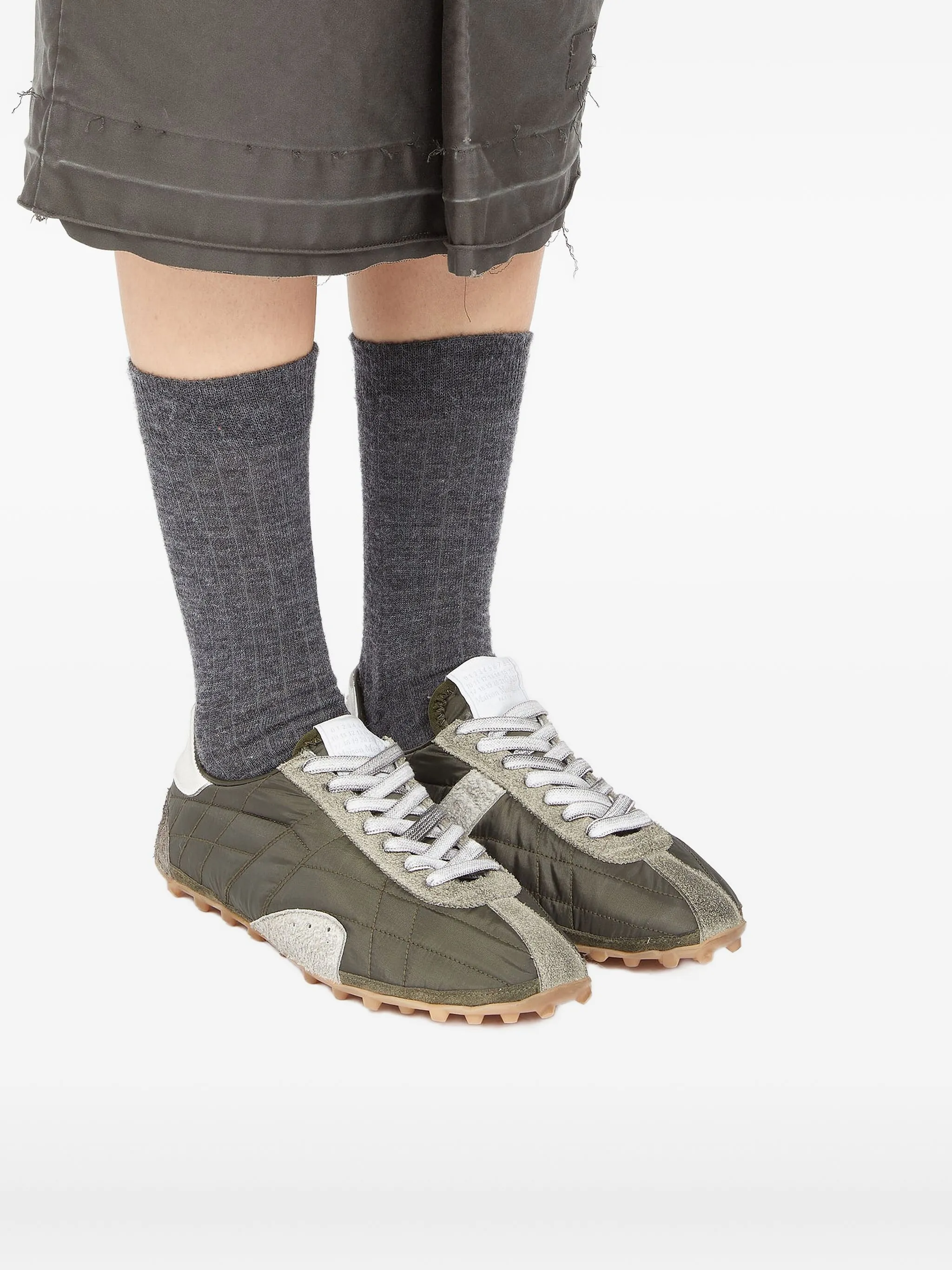 Green shoes worn by a person, showing the shoes fit