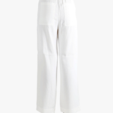 white pants worn by a person, showing the pants  fit