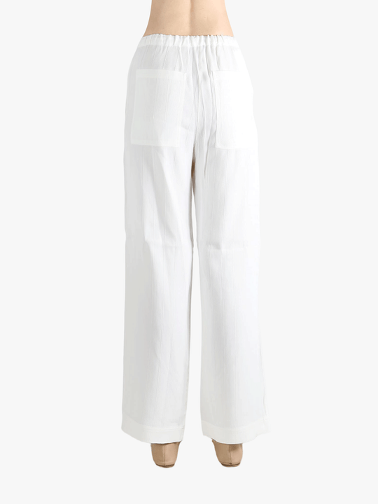 white pants worn by a person, showing the pants  fit