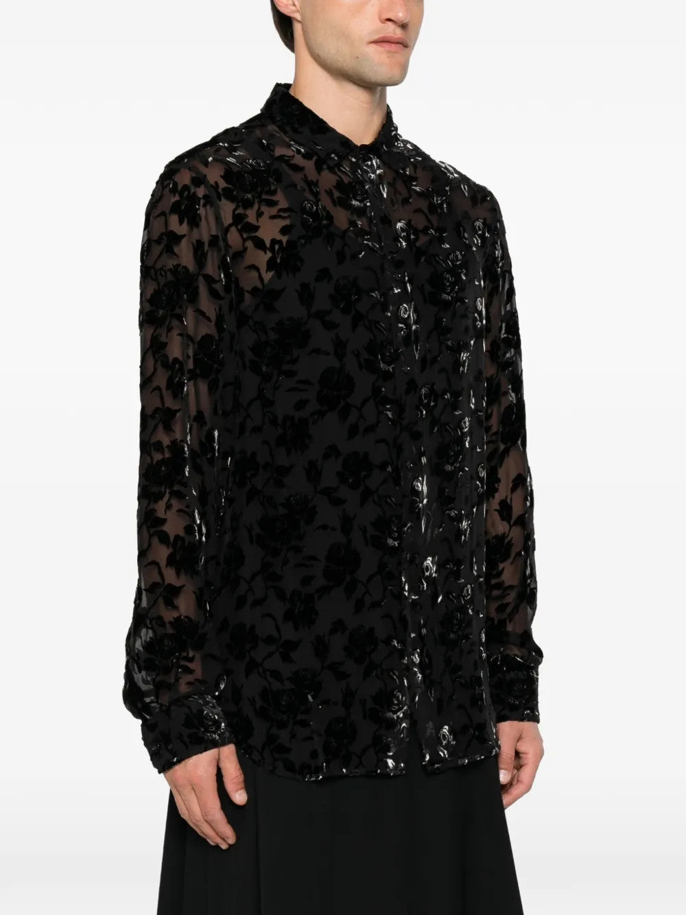 Black shirt worn by a person, showing the shirt fit