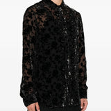 Black shirt worn by a person, showing the shirt fit
