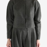 Grey tops worn by a person, showing the tops fit