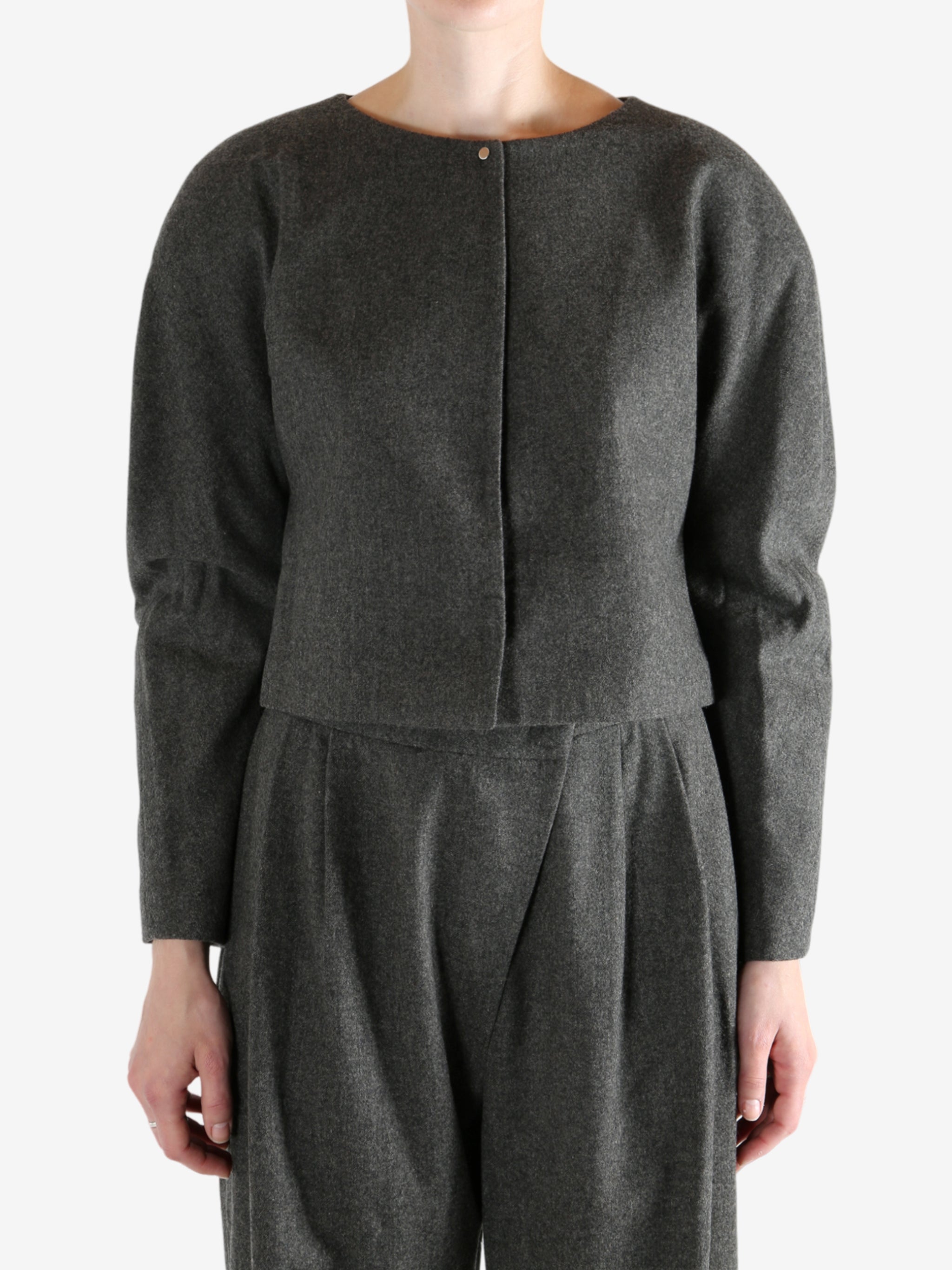 Grey tops worn by a person, showing the tops fit