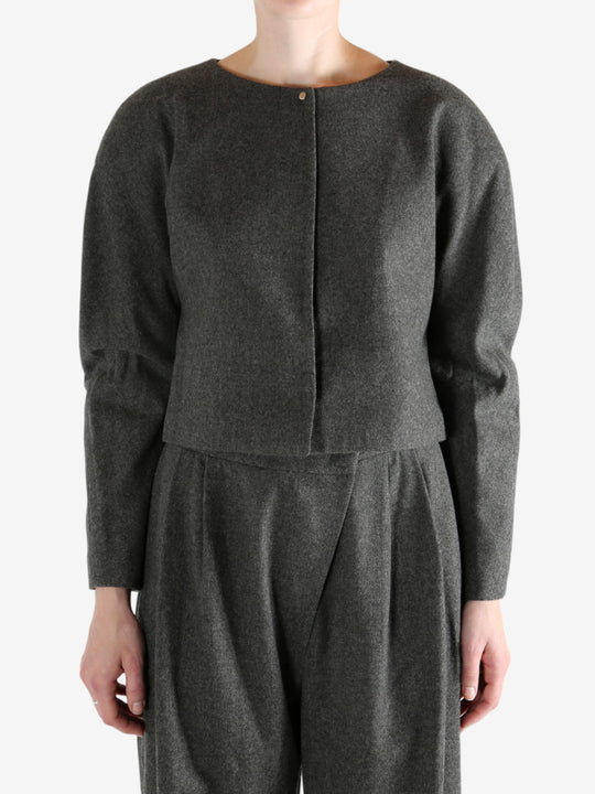 Grey tops worn by a person, showing the tops fit