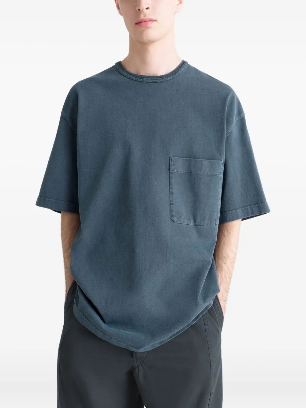 Blue t-shirt worn by a person, showing the t-shirt's fit