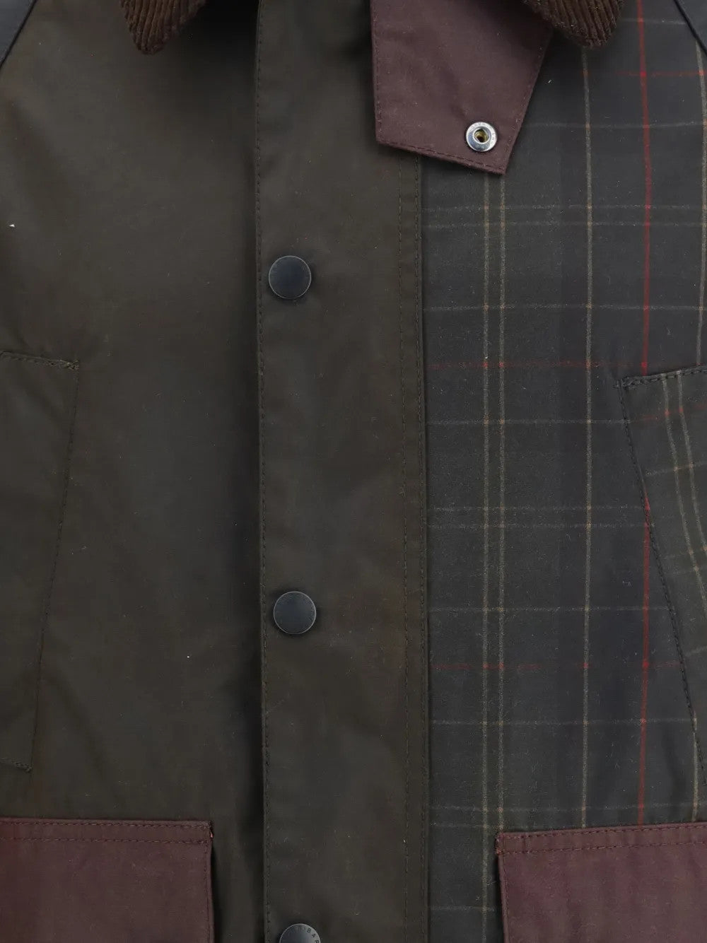 Close up of Brown jacket, showing texture of the corduroy fabric