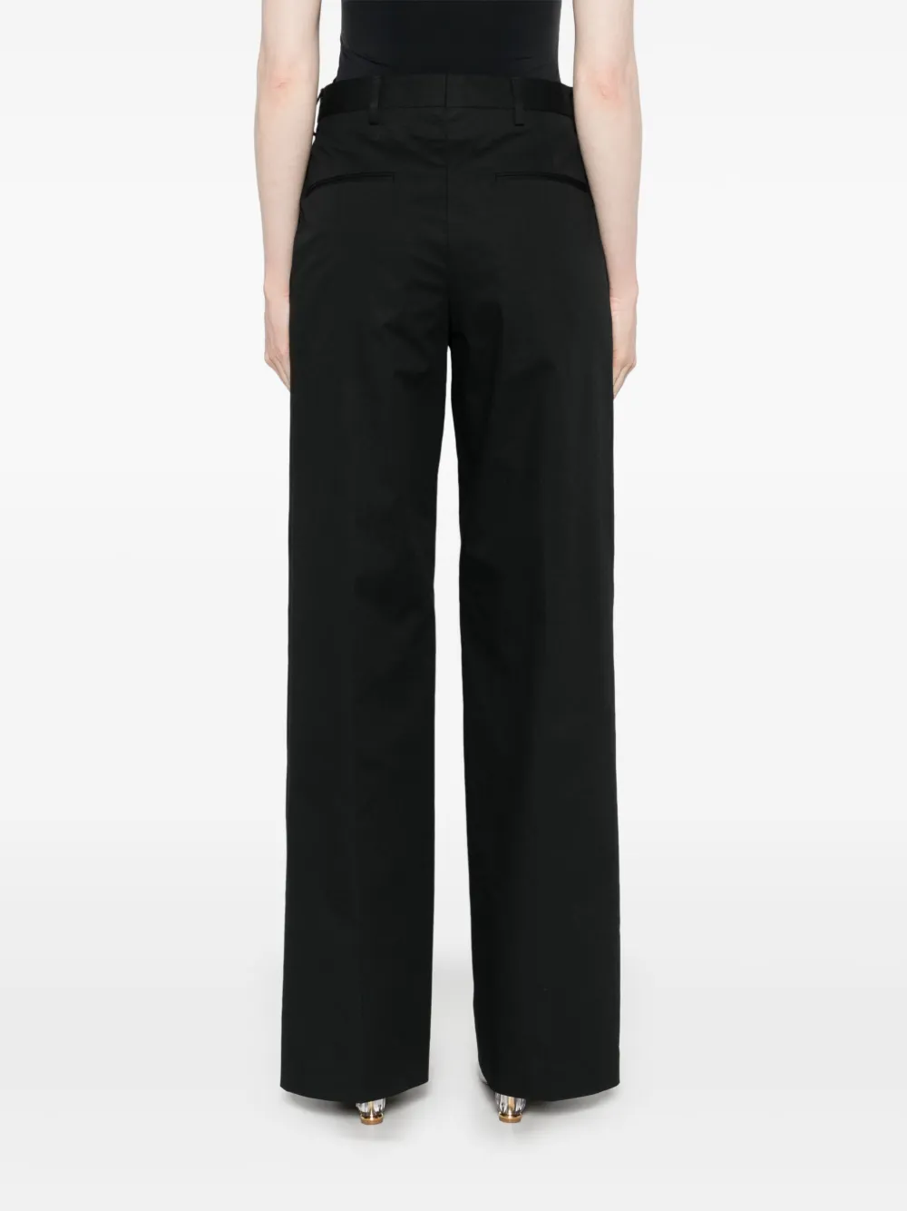 Black pant worn by a person, showing the  pant's fit