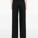 Black pant worn by a person, showing the  pant's fit