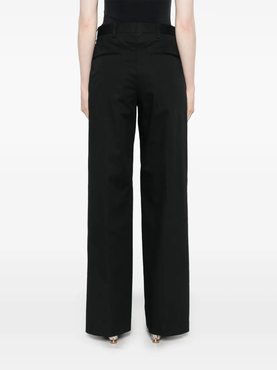 Black pant worn by a person, showing the  pant's fit