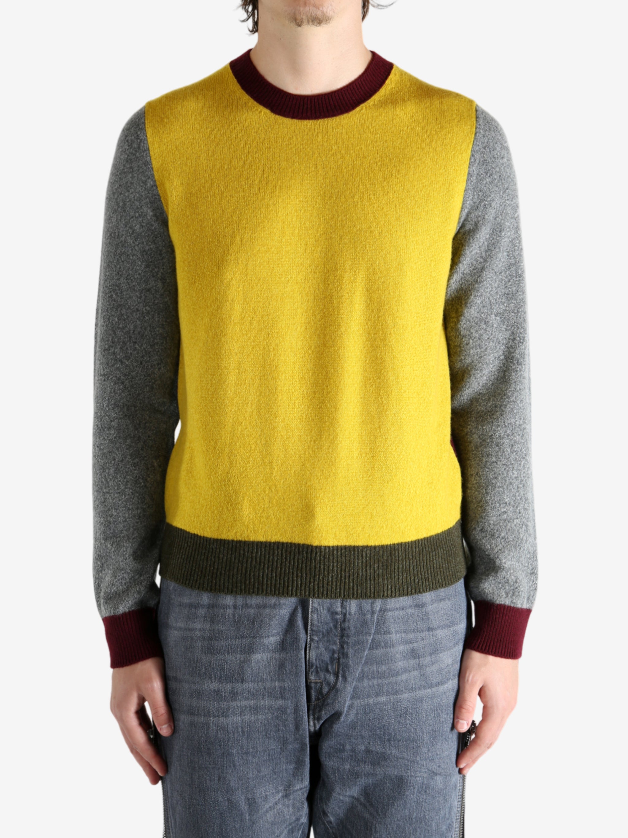 Grey knitwear worn by a person, showing the knitwear's fit