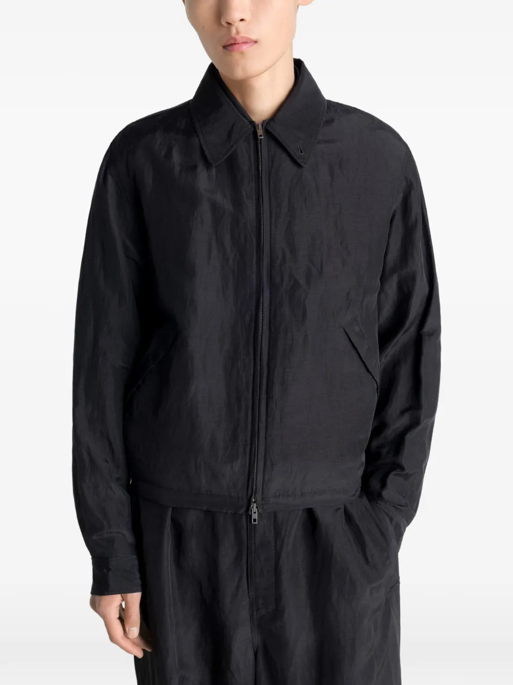 Black jacket worn by a person, showing the jacket's fit