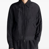 Black jacket worn by a person, showing the jacket's fit