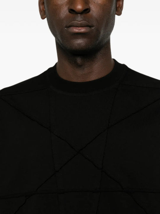 Black t-shirt worn by a person, showing the t-shirt fit
