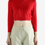 Red cardigan worn by a person, showing the cardigan's fit