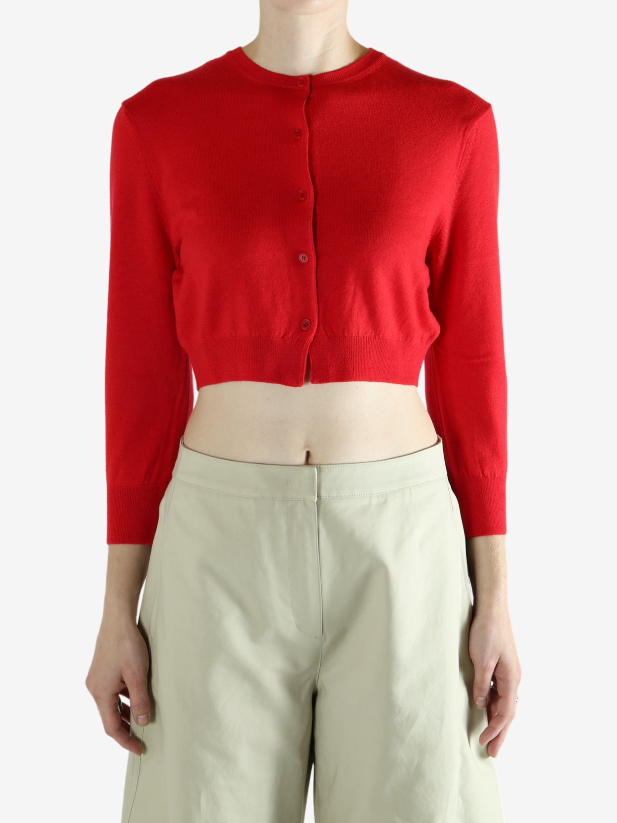 Red cardigan worn by a person, showing the cardigan's fit
