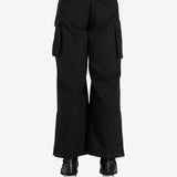 Black pants worn by a person, showing the pants's fit