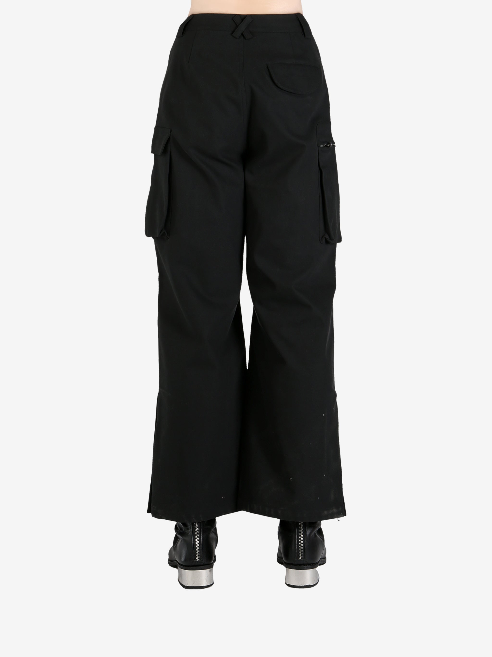 Black pants worn by a person, showing the pants's fit