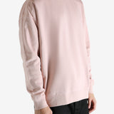 Pink sweatshirt worn by a person, showing the sweatshirt's fit