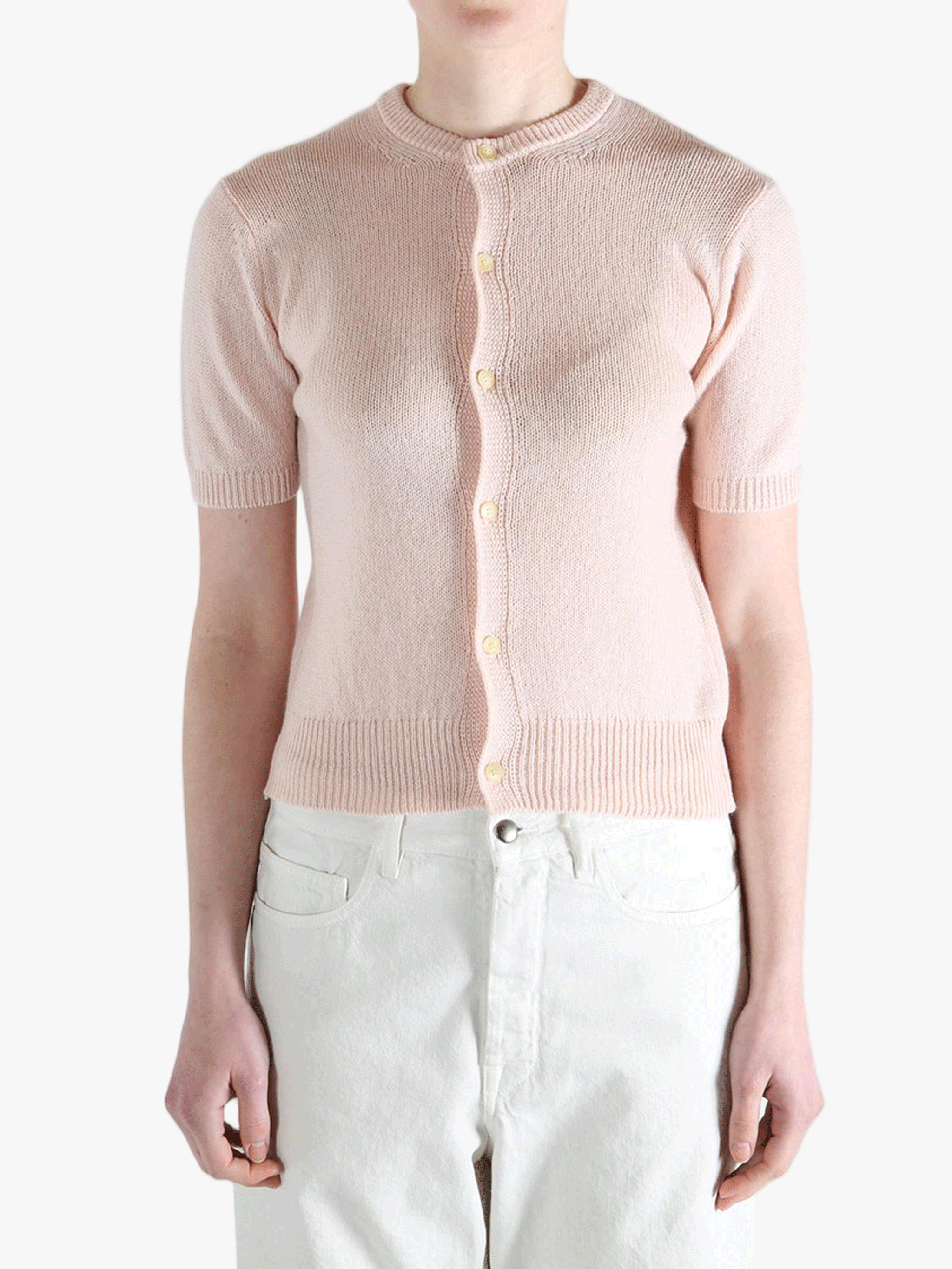 Pink knitwear worn by a person, showing the knitwear's fit