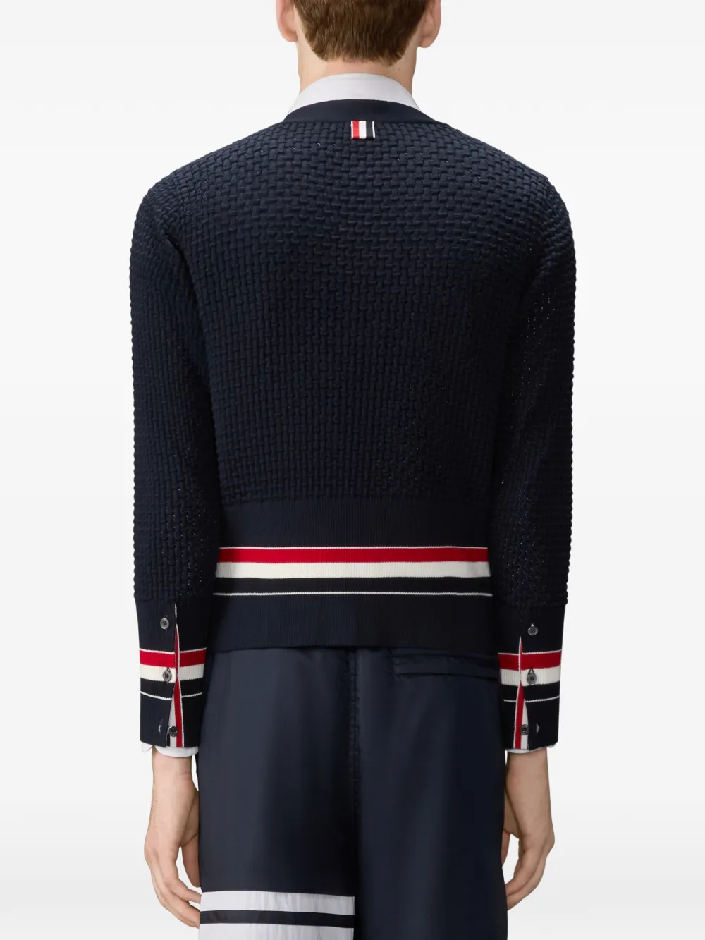 Black knitwear worn by a person, showing the knitwear fit