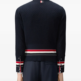 Black knitwear worn by a person, showing the knitwear fit