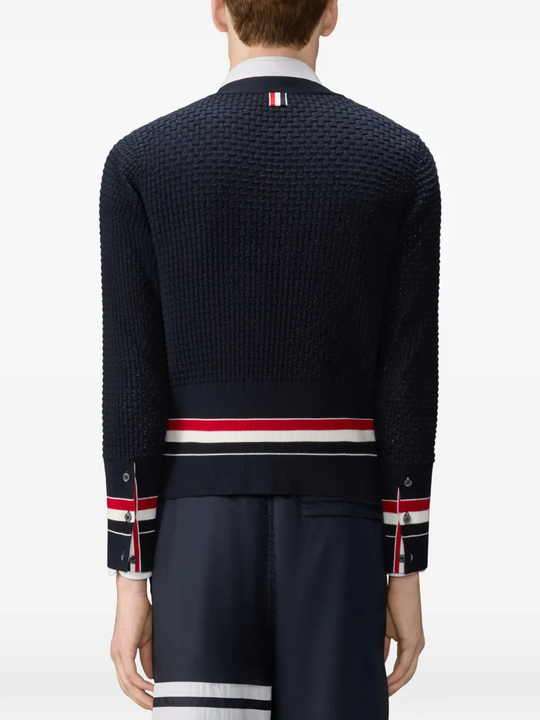 Black knitwear worn by a person, showing the knitwear fit