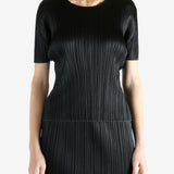 Black shirts worn by a person, showing the shirts fit