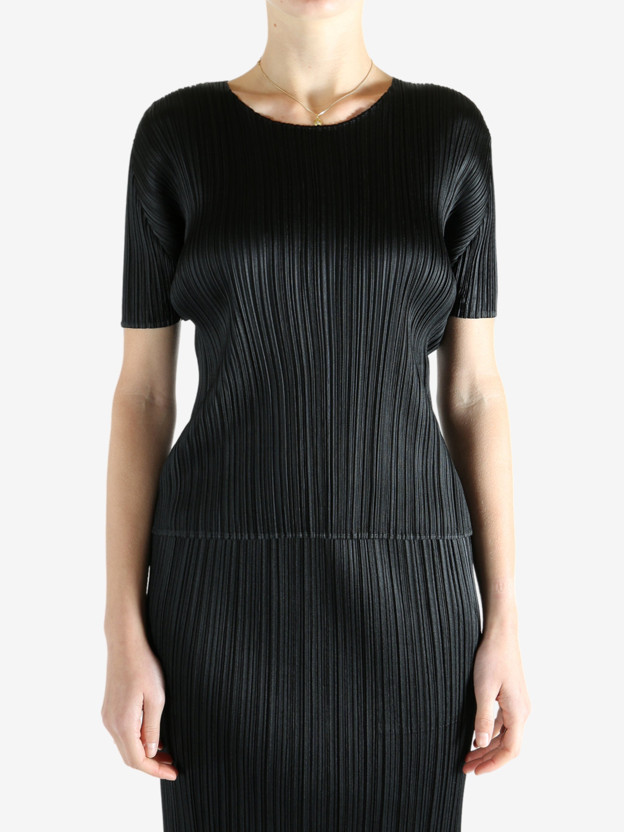 Black shirts worn by a person, showing the shirts fit