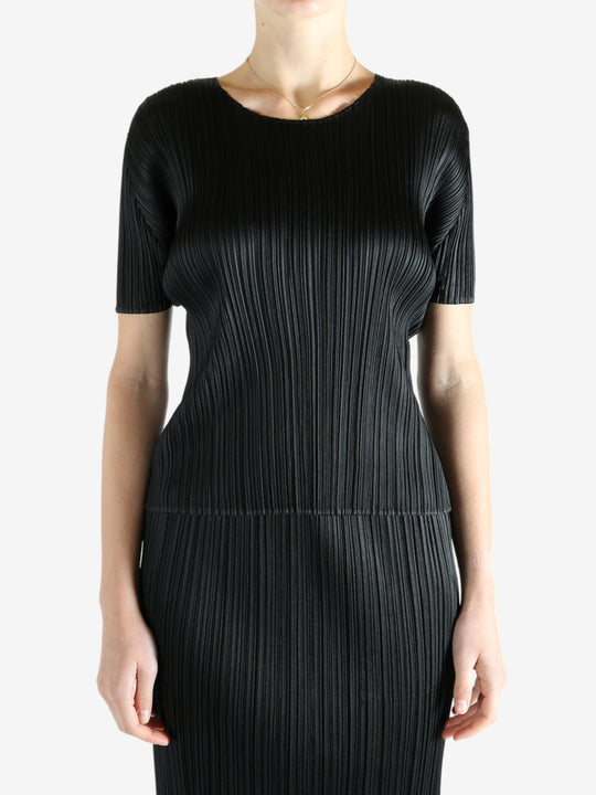 Black shirts worn by a person, showing the shirts fit