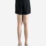 Black shorts worn by a person, showing the shorts' fit