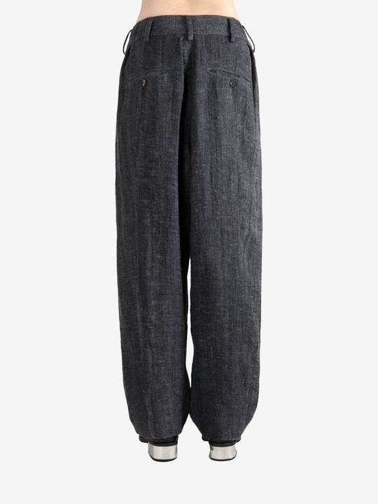 Black pants,worn by a person, showing the pants's fit