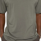 Grey t-shirt worn by a person, showing the t-shirt fit